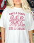Close-up of model wearing white color shirt with 'Save A Horse Ride A Cowgirl' graphic design
